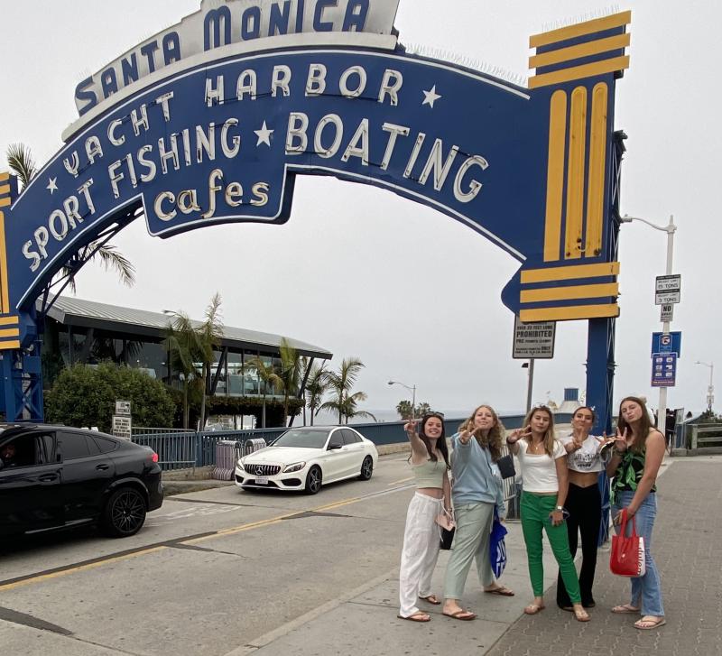 Administrative Support Team members (l-r) Kate Hill, Emily Wells, Macy Davis and Elena Booth gather at the Santa Monica Pier.
